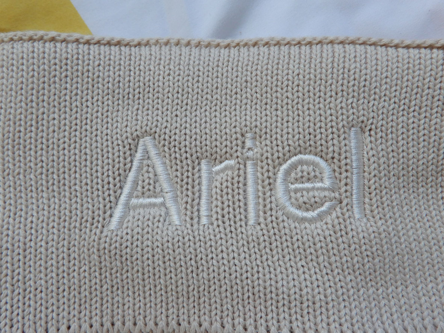 Stone baby knit blanket. Personalised in white thread in bold font.