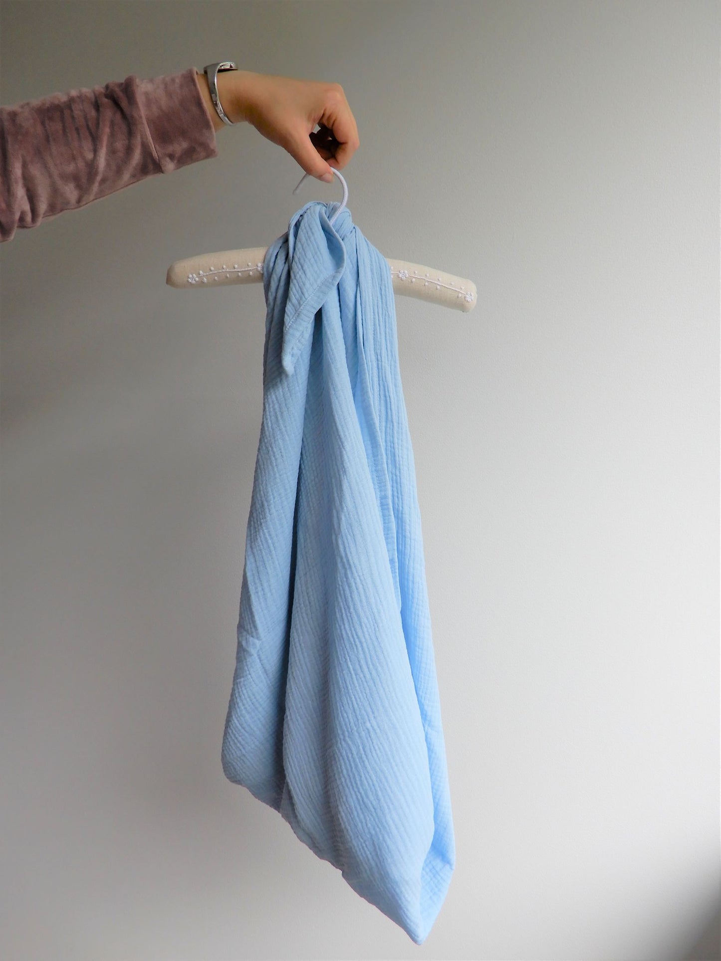 Blue muslin wrap hung