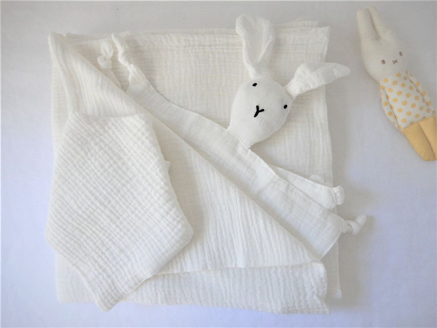 White muslin wrap and bib set, also includes bunny comforter. All items can be personalised. Bunny can be personalised with birth date. 