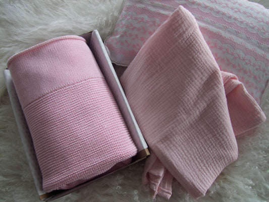 Pink baby knit blanket paired with pink muslin wrap. Both can be personalised to your liking and boxed for delivery.