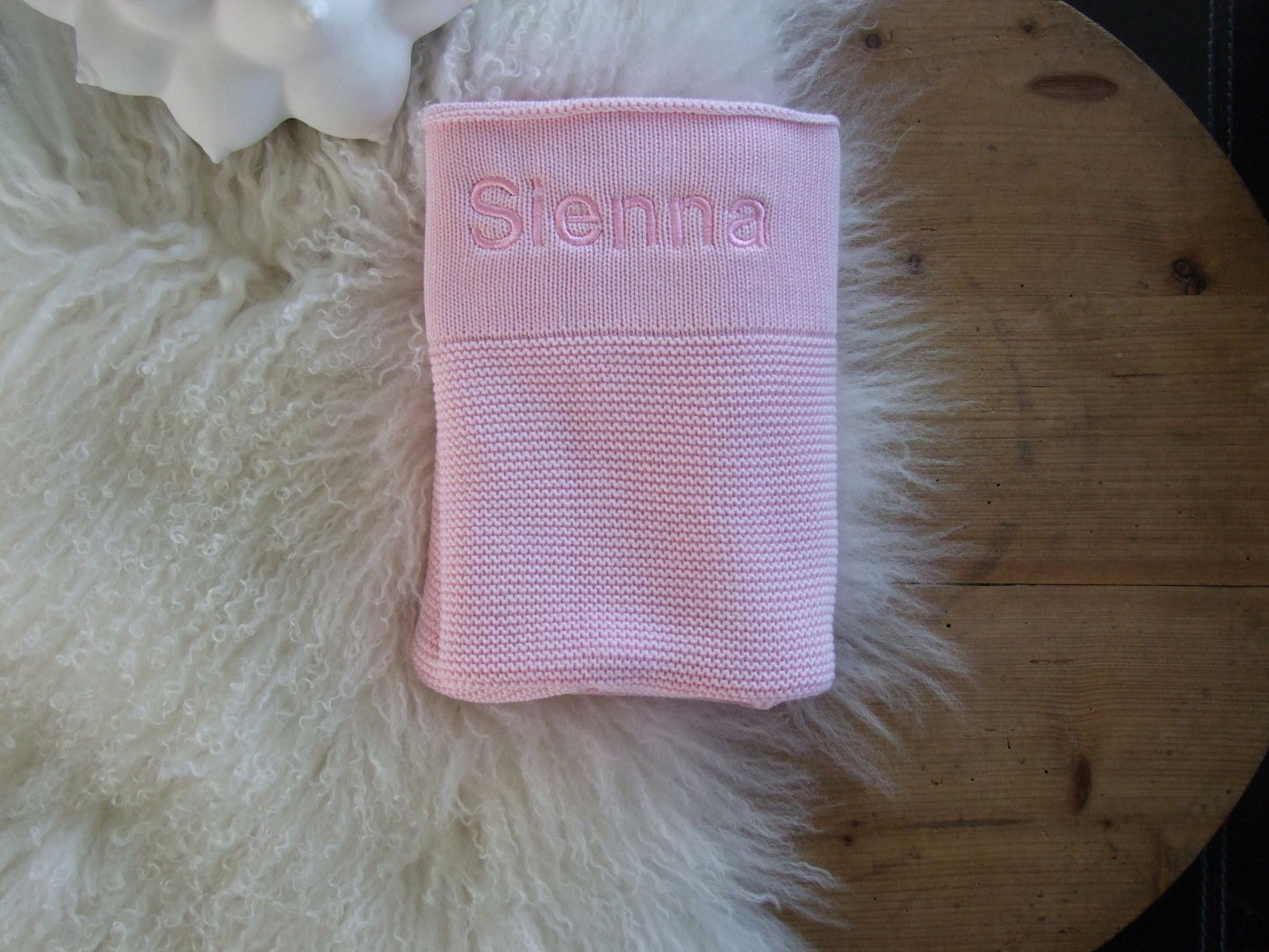 Pink knit baby blanket. Personalised with pink thread in bold font.